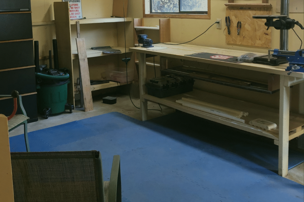 Interior of Pins and Springs Gunsmithing workshop with workbench, tools, and organized storage, reflecting the precision and craftsmanship in firearm care.