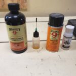 A set of four different oils and solvents to clean guns.
